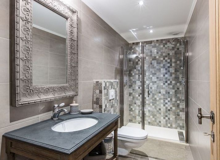 Charming interior of Holiday Home Villa 'Marie France' Wellness in Stavelot, Ardennes, with rustic wooden chest of drawers and decorations.