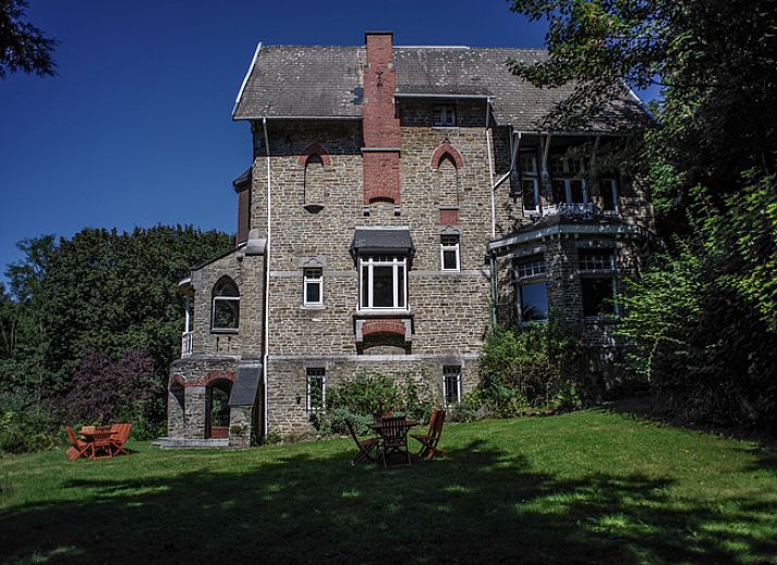 Stijlvolle eetkamer in La Merveille de Mery, vakantiehuis in Esneux, met houten interieur.
