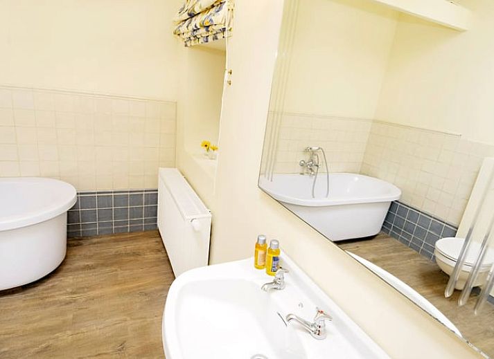 Ruime slaapkamer in Vakantiehuis in Wodecq met houten vloer en warme verlichting, Henegouwen, Belgie.