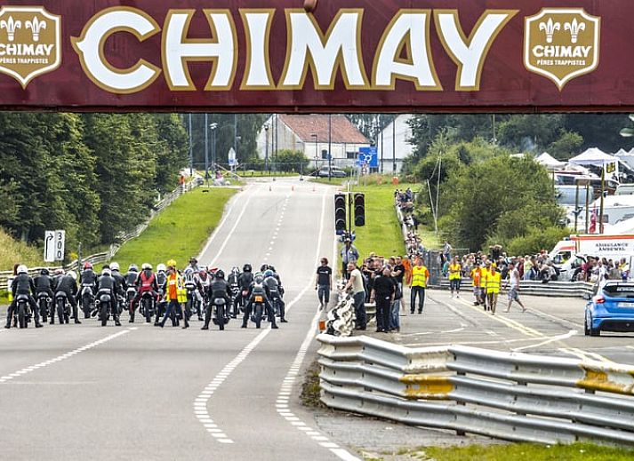 Cozy living room of Cottage in Sivry, Hainaut, Belgium, with comfortable sitting area and rustic stone walls.