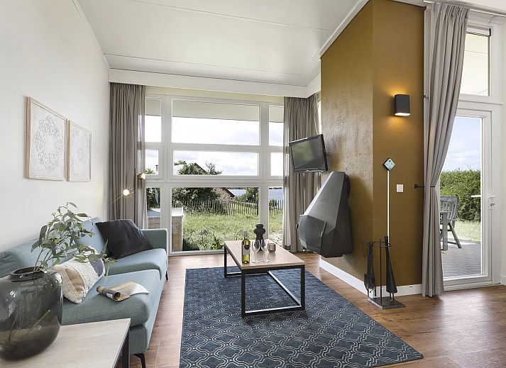 Cozy living room of Village l'Eau d'Heure 4-person dog bungalow in Froidchapelle, Hainaut overlooking nature.