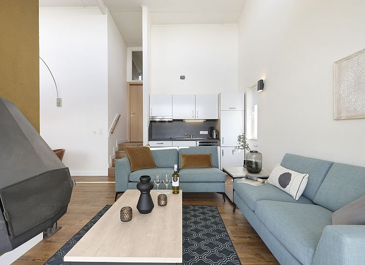 Stylish living room in Village l'Eau d'Heure 4-person dog bungalow, Froidchapelle, Hainaut, Belgium with modern furniture and open kitchen.