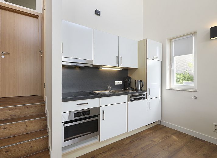 Stylish living room in Village l'Eau d'Heure 4-person dog bungalow, Froidchapelle, Hainaut, Belgium with modern furniture and open kitchen.