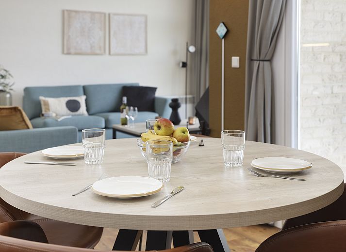 Stylish living room in Village l'Eau d'Heure 4-person dog bungalow, Froidchapelle, Hainaut, Belgium with modern furniture and open kitchen.