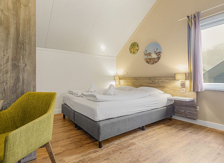 Stylish living room in Village l'Eau d'Heure 6-bed bungalow, Froidchapelle, Hainaut, Belgium with modern decor and cozy sitting area.