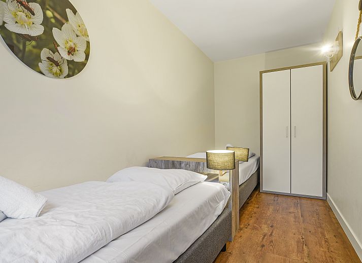 Cozy interior of Village l'Eau d'Heure 6-bed bungalow in Froidchapelle, Hainaut, Belgium, with modern kitchen and sitting area.