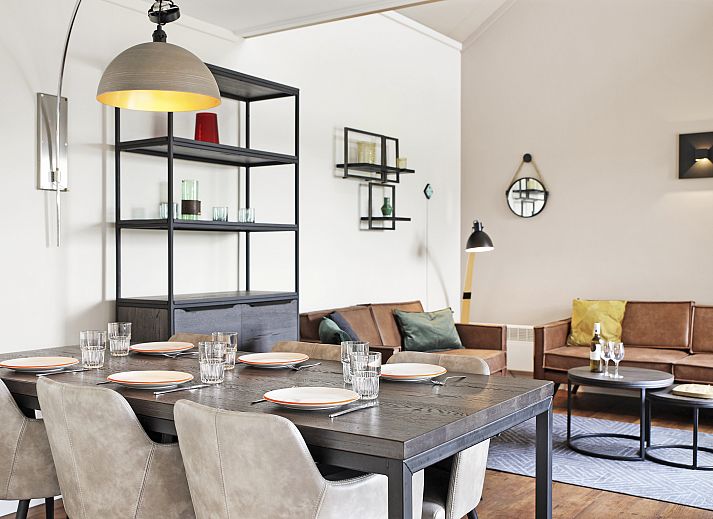 Cozy interior of Village l'Eau d'Heure 6-bed bungalow in Froidchapelle, Hainaut, Belgium, with modern kitchen and sitting area.