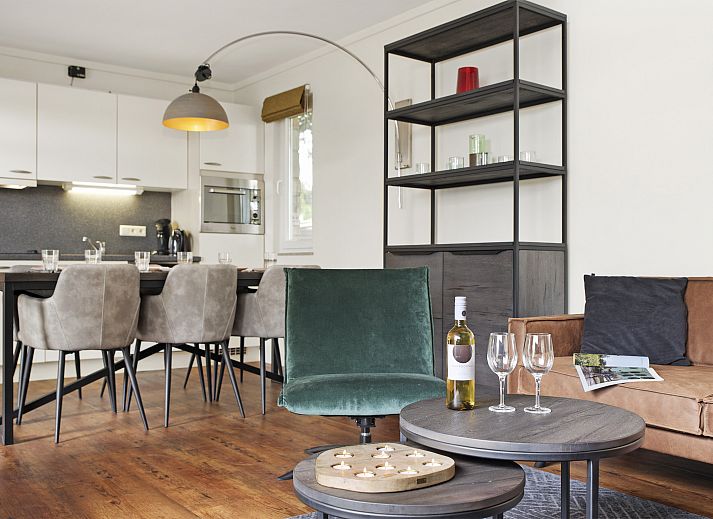 Cozy interior of Village l'Eau d'Heure 6-bed bungalow in Froidchapelle, Hainaut, Belgium, with modern kitchen and sitting area.
