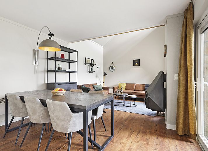 Cozy interior of Village l'Eau d'Heure 6-bed bungalow in Froidchapelle, Hainaut, Belgium, with modern kitchen and sitting area.