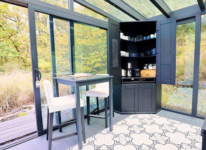 Enjoy relaxation and games at Chalet Agathe, Laforet, Ardennes. Bright indoor space with ping pong table and views of nature.