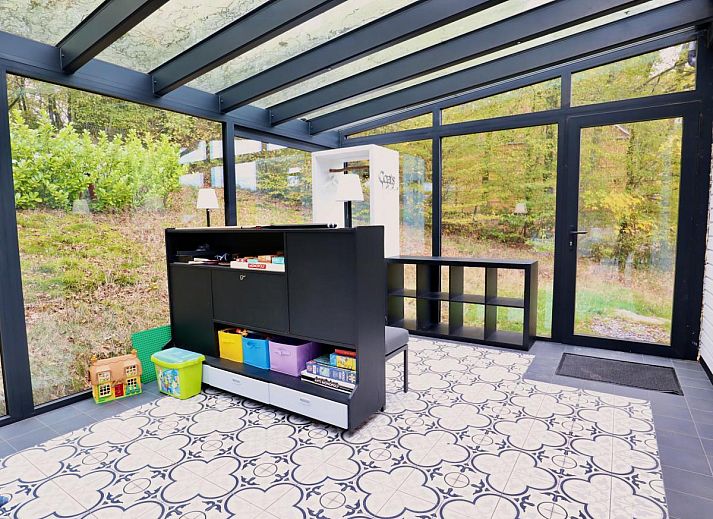 Enjoy relaxation and games at Chalet Agathe, Laforet, Ardennes. Bright indoor space with ping pong table and views of nature.