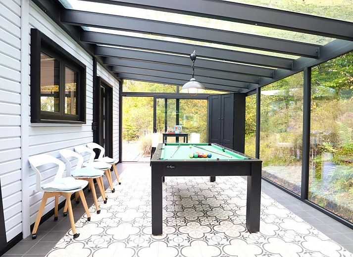 Enjoy relaxation and games at Chalet Agathe, Laforet, Ardennes. Bright indoor space with ping pong table and views of nature.