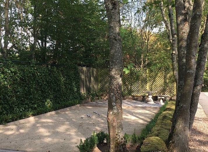 Romantisches Schlafzimmer in Les Confidences de Messire Sanglier, Ferienhaus in Beauraing, mit Holzbalken und Blumenmuster.