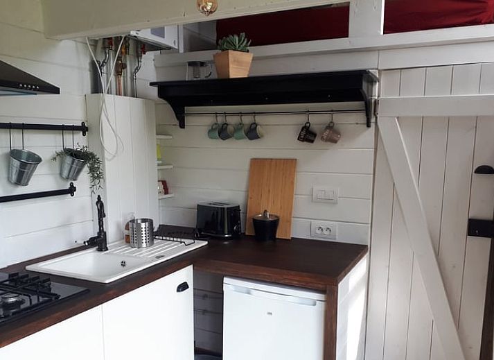Snowy landscape around Cottage in Gesves, a cottage in the Ardennes, with a charming wooden veranda.