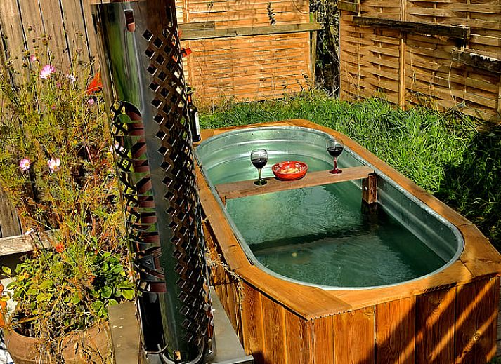 Snowy landscape around Cottage in Gesves, a cottage in the Ardennes, with a charming wooden veranda.