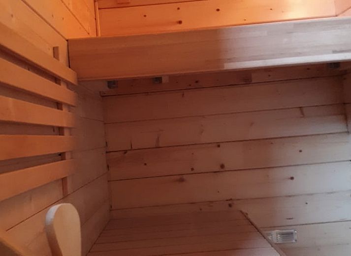 Outdoor area of Cottage in Gesves with fire basket and colorful chairs, vacation home in Ardennes, Belgium.