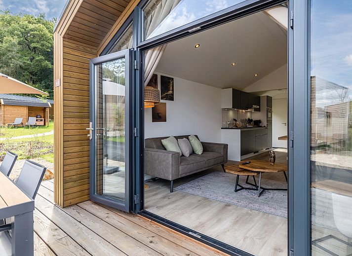 Gemuetliches Interieur der 4-Bett-Huette 4B2 in Gesves, Ardennen, Belgien, mit moderner Einrichtung und Blick auf die Natur.