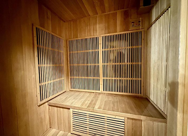 Enjoy the terrace of Leora Cosy vacation home in Membre, Ardennes, overlooking the green hills and an inviting garden.