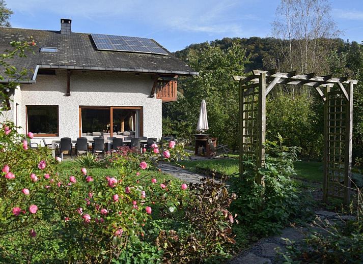 Enjoy the terrace of Leora Cosy vacation home in Membre, Ardennes, overlooking the green hills and an inviting garden.