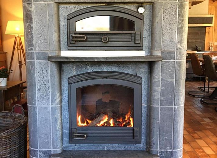 Enjoy the terrace of Leora Cosy vacation home in Membre, Ardennes, overlooking the green hills and an inviting garden.