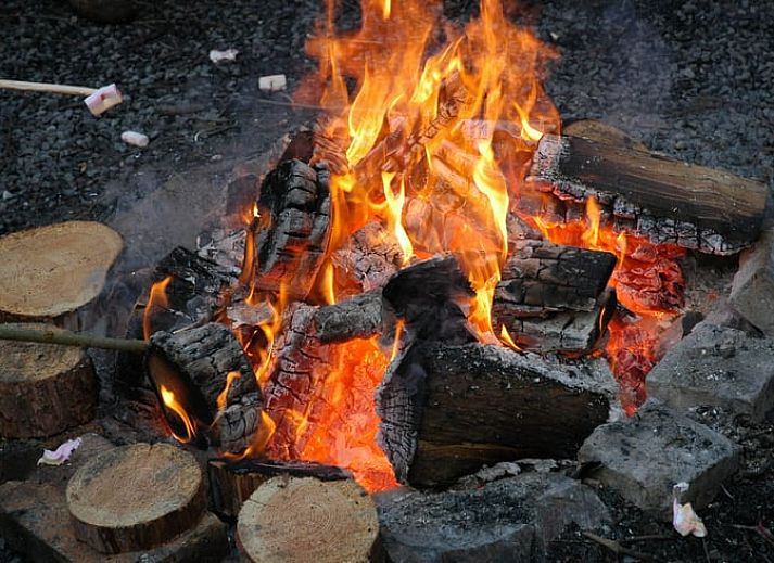 Charmantes Ferienhaus in Purnode, in den Ardennen, Belgien, mit rustikaler Steinfassade und einladender roter Tuer.