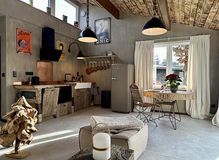 Attractive bedroom in vacation home Chez Brigitte, Durbuy, Ardennes, Belgium, with rustic wooden bed and green accents for a relaxing stay.