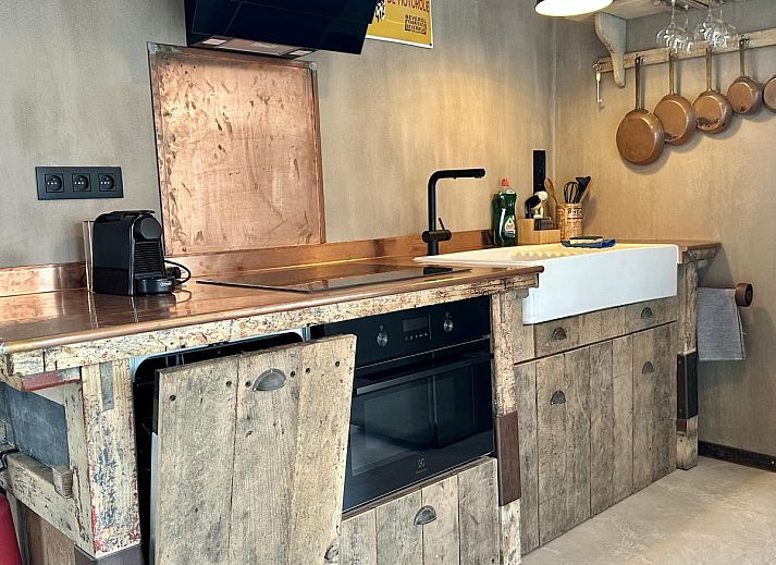 Luxury bathroom in Chez Brigitte vacation home, Durbuy, Ardennes, with modern bathtub and rustic sink for ultimate relaxation.