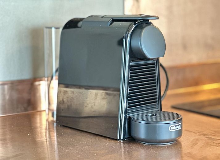 Stylish bedroom and luxury bath in Chez Brigitte, a vacation home in Durbuy, Ardennes, Belgium, with rustic charm and comfort.