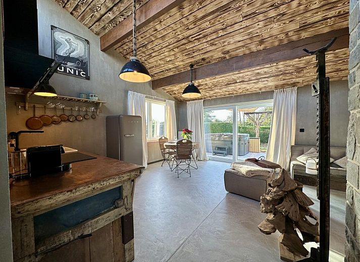 Stylish bedroom and luxury bath in Chez Brigitte, a vacation home in Durbuy, Ardennes, Belgium, with rustic charm and comfort.