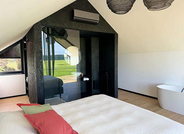 Gezellige woonkamer in Escapade romantique, vakantiehuis in Durbuy, met uitzicht op de groene omgeving van de Ardennen.
