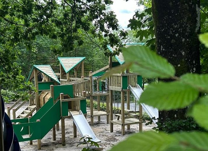Cozy living room of Chalet Du Bois IV in Durbuy, Ardennes, Belgium with comfortable seating area and views of nature.
