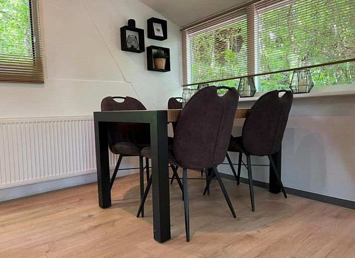 Cozy living room of Chalet Du Bois IV in Durbuy, Ardennes, Belgium with comfortable seating area and views of nature.