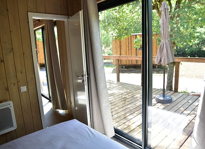 Ecolodge vacation home in Houffalize, Ardennes, Belgium with wooden terrace and surrounded by nature.