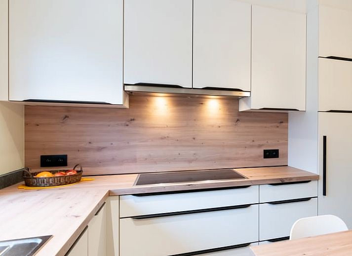 Quiet garden of vacation home in Ortho, surrounded by colorful flowers and greenery, in Ardennes, Luxembourg.