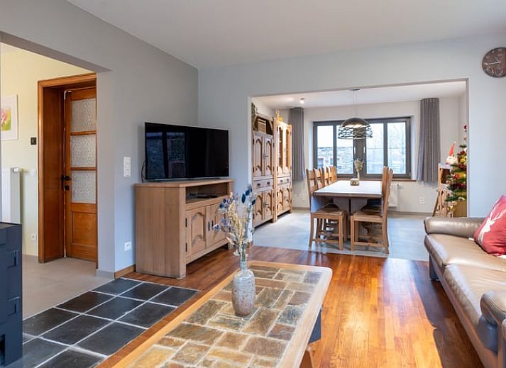 Quiet garden of vacation home in Ortho, surrounded by colorful flowers and greenery, in Ardennes, Luxembourg.