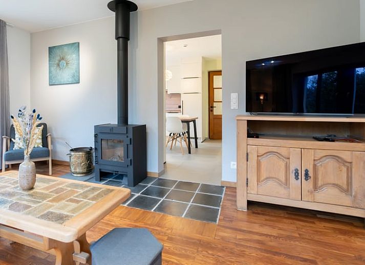 Quiet garden of vacation home in Ortho, surrounded by colorful flowers and greenery, in Ardennes, Luxembourg.