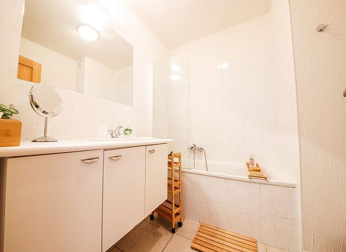 Gezellige woonkamer in vakantiehuis Castelgolf, Barvaux, Ardennen met moderne open haard en stijlvolle inrichting.