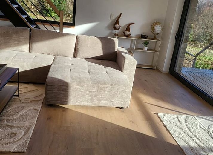Veranda of Cottage in Grandmenil, located in Ardennes, Belgium, overlooking green nature and sunny garden.