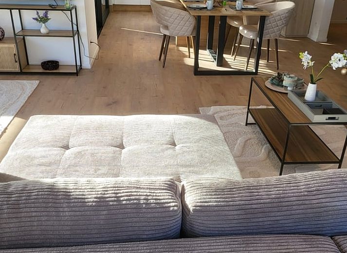 Veranda of Cottage in Grandmenil, located in Ardennes, Belgium, overlooking green nature and sunny garden.