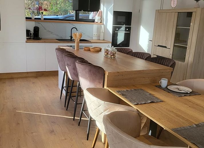 Veranda of Cottage in Grandmenil, located in Ardennes, Belgium, overlooking green nature and sunny garden.