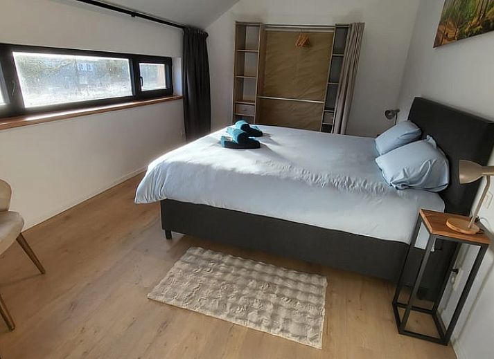 Veranda of Cottage in Grandmenil, located in Ardennes, Belgium, overlooking green nature and sunny garden.