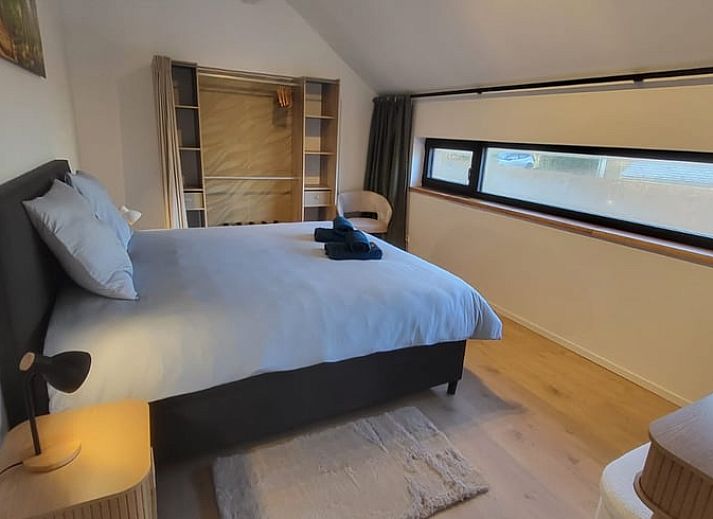 Cozy interior of Cottage in Grandmenil, vacation home in Ardennes, Belgium with modern kitchen and comfortable seating area.