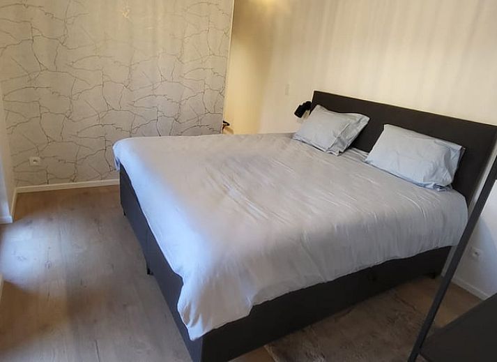 Cozy interior of Cottage in Grandmenil, vacation home in Ardennes, Belgium with modern kitchen and comfortable seating area.