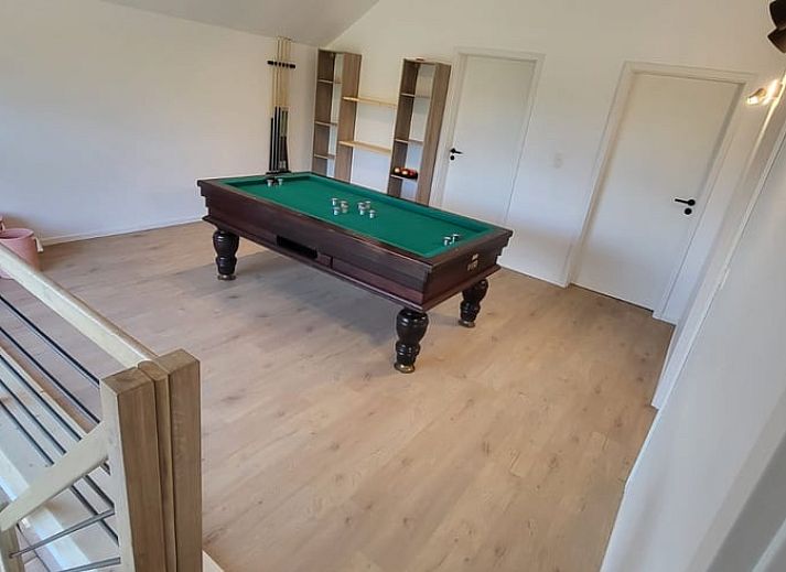 Cozy interior of Cottage in Grandmenil, vacation home in Ardennes, Belgium with modern kitchen and comfortable seating area.