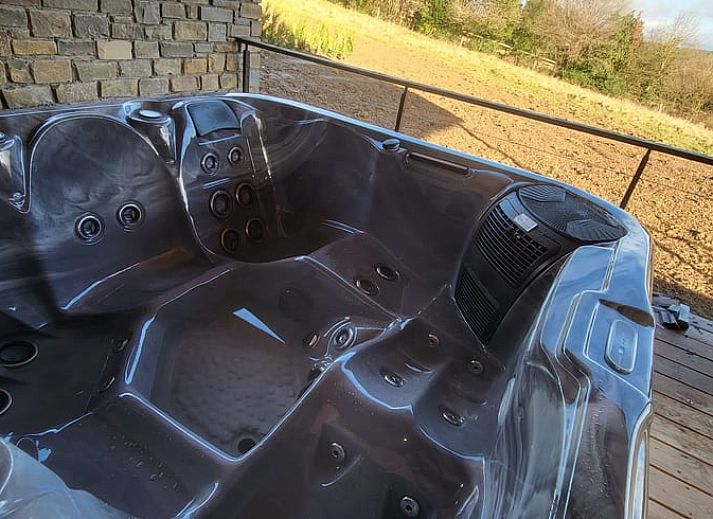 Cozy interior of Cottage in Grandmenil, vacation home in Ardennes, Belgium with modern kitchen and comfortable seating area.