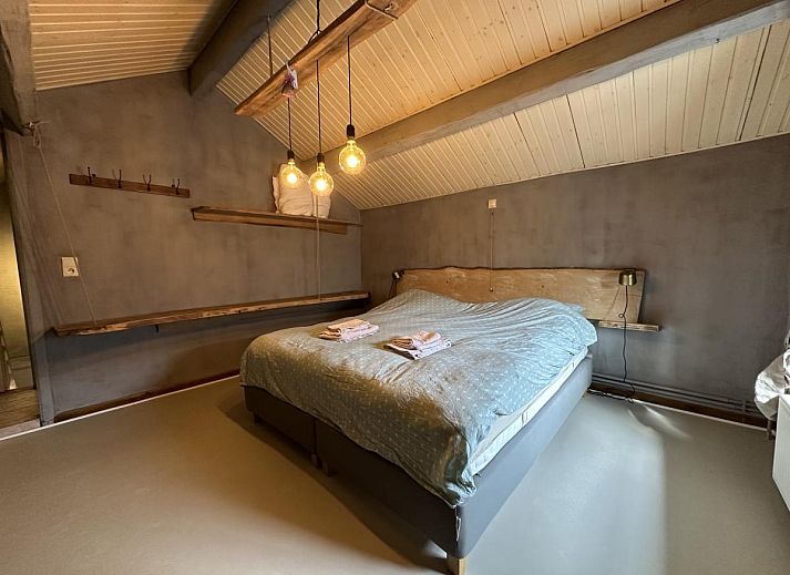 Gezellige zithoek in Le Fournil vakantiehuis, Manhay, Ardennen, Belgie, met comfortabele bank en hout voor open haard.