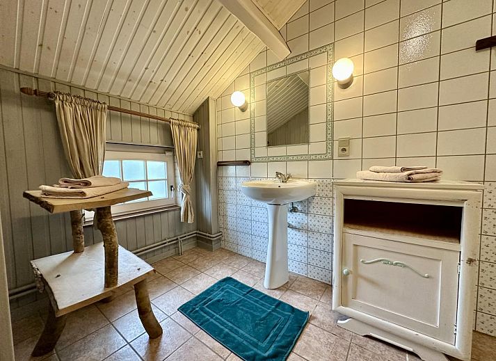 Gezellige zithoek in Le Fournil vakantiehuis, Manhay, Ardennen, Belgie, met comfortabele bank en hout voor open haard.