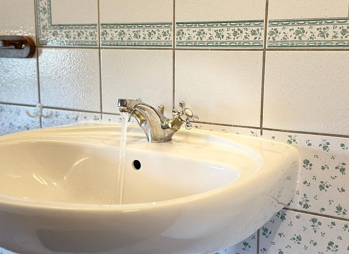 Gezellige zithoek in Le Fournil vakantiehuis, Manhay, Ardennen, Belgie, met comfortabele bank en hout voor open haard.