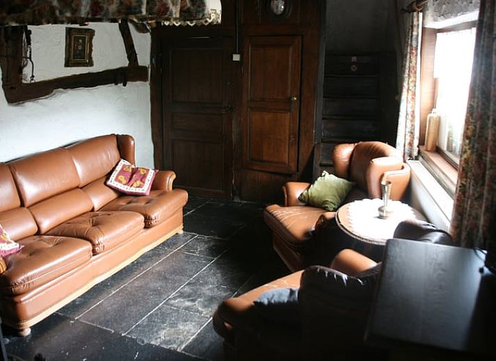 Authentic kitchen shelf in Cottage in Buisson, cottage in the Ardennes, Belgium, with rustic plates and mugs for a cozy atmosphere.