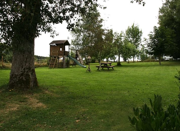 Authentic kitchen shelf in Cottage in Buisson, cottage in the Ardennes, Belgium, with rustic plates and mugs for a cozy atmosphere.